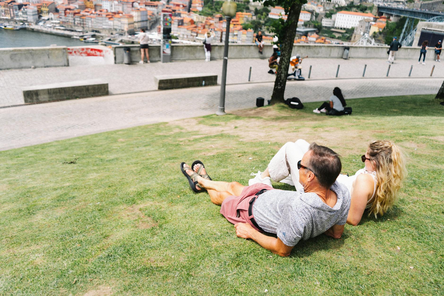 Couple enjoying a sunny view from Jardim do Morro in Porto
