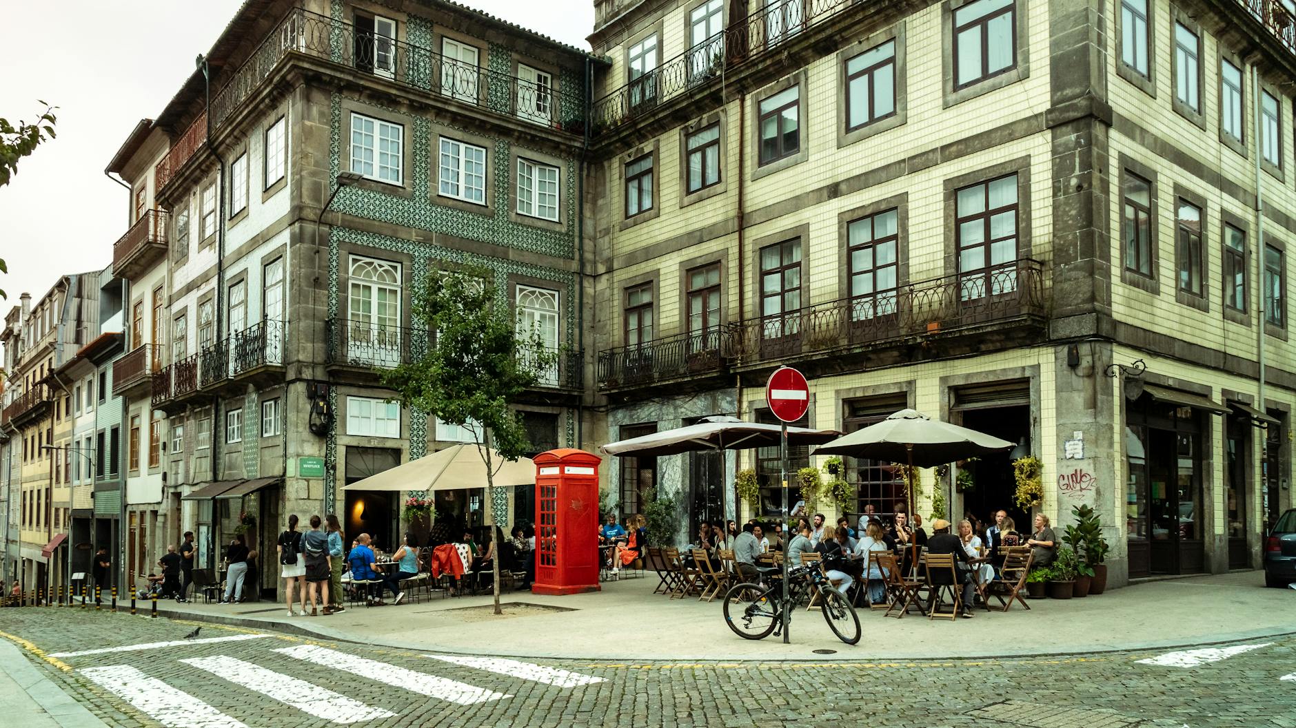 Lively cafe on a Porto street with classic architecture
