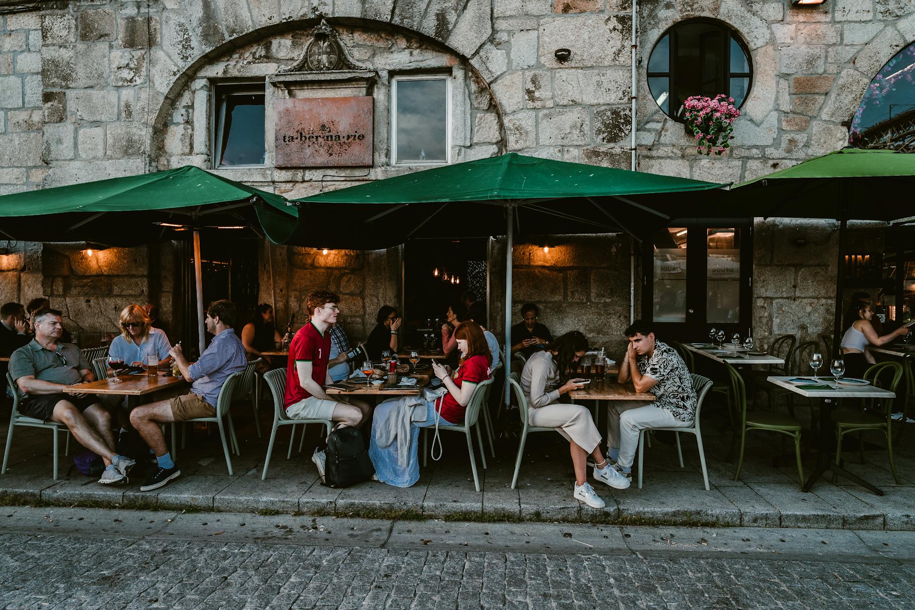 People dining outside at a historic Porto cafe