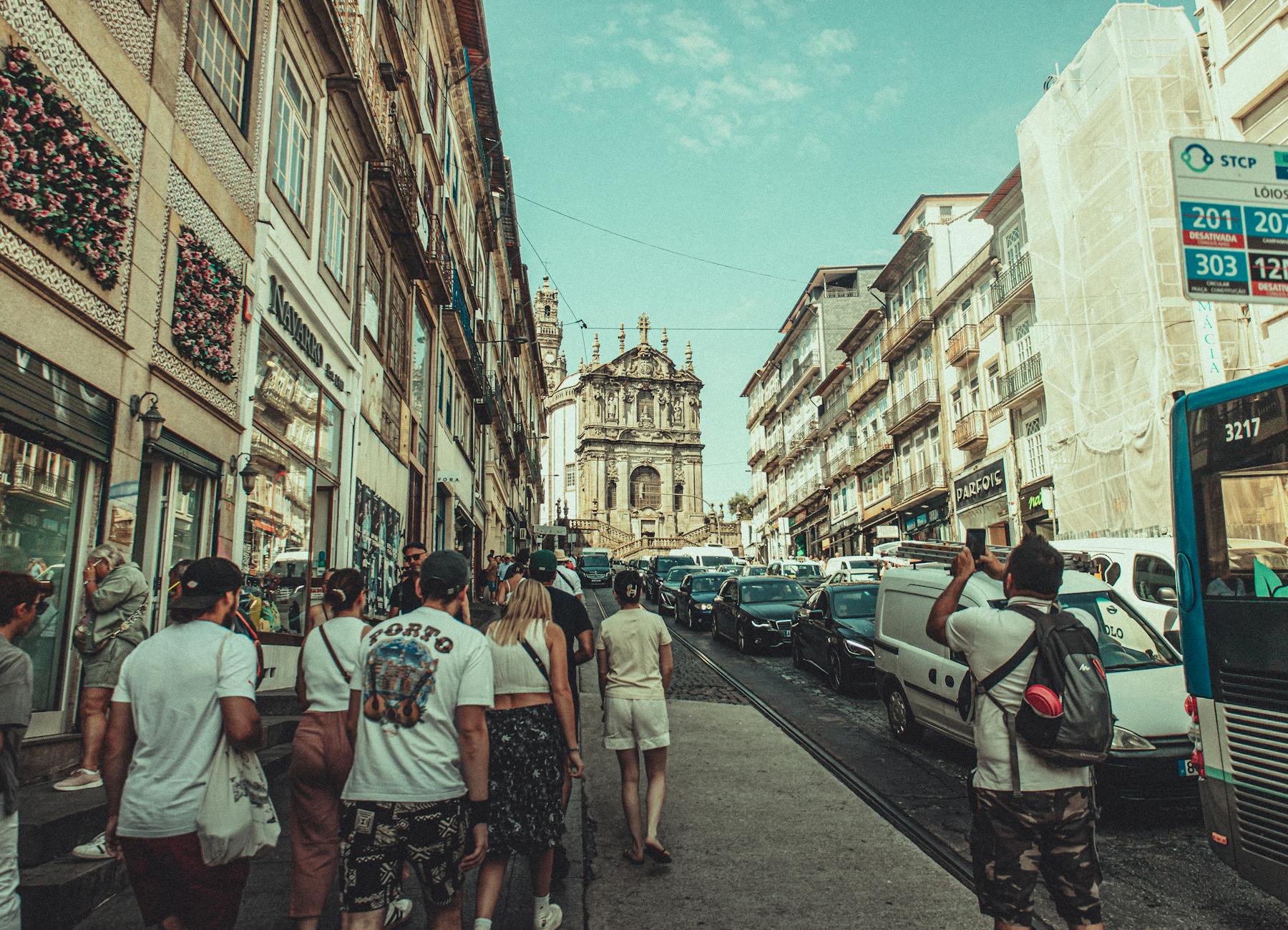 Busy Porto street with classic architecture and pedestrians