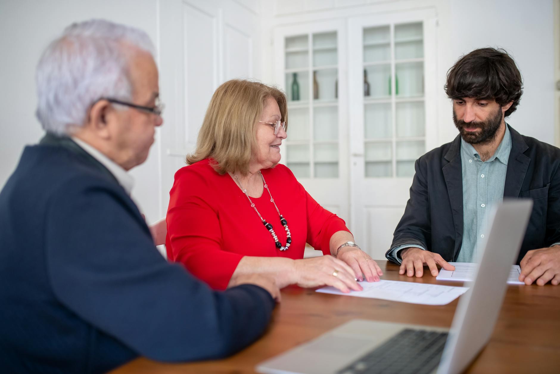 Business professionals discussing documents in a meeting