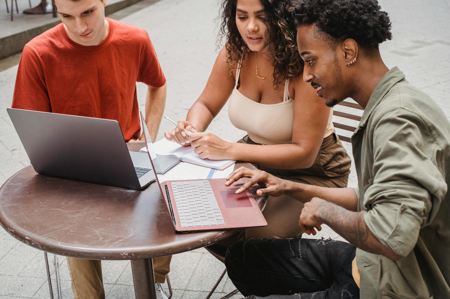 Students working on laptops at an outdoor cafe