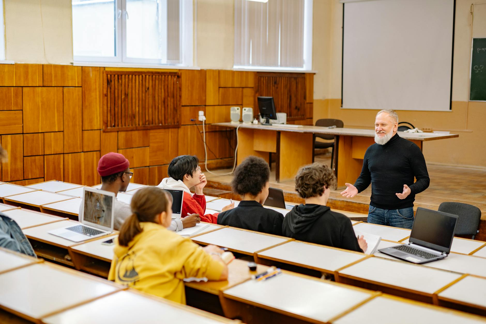 Students engaging with a professor in a university lecture hall