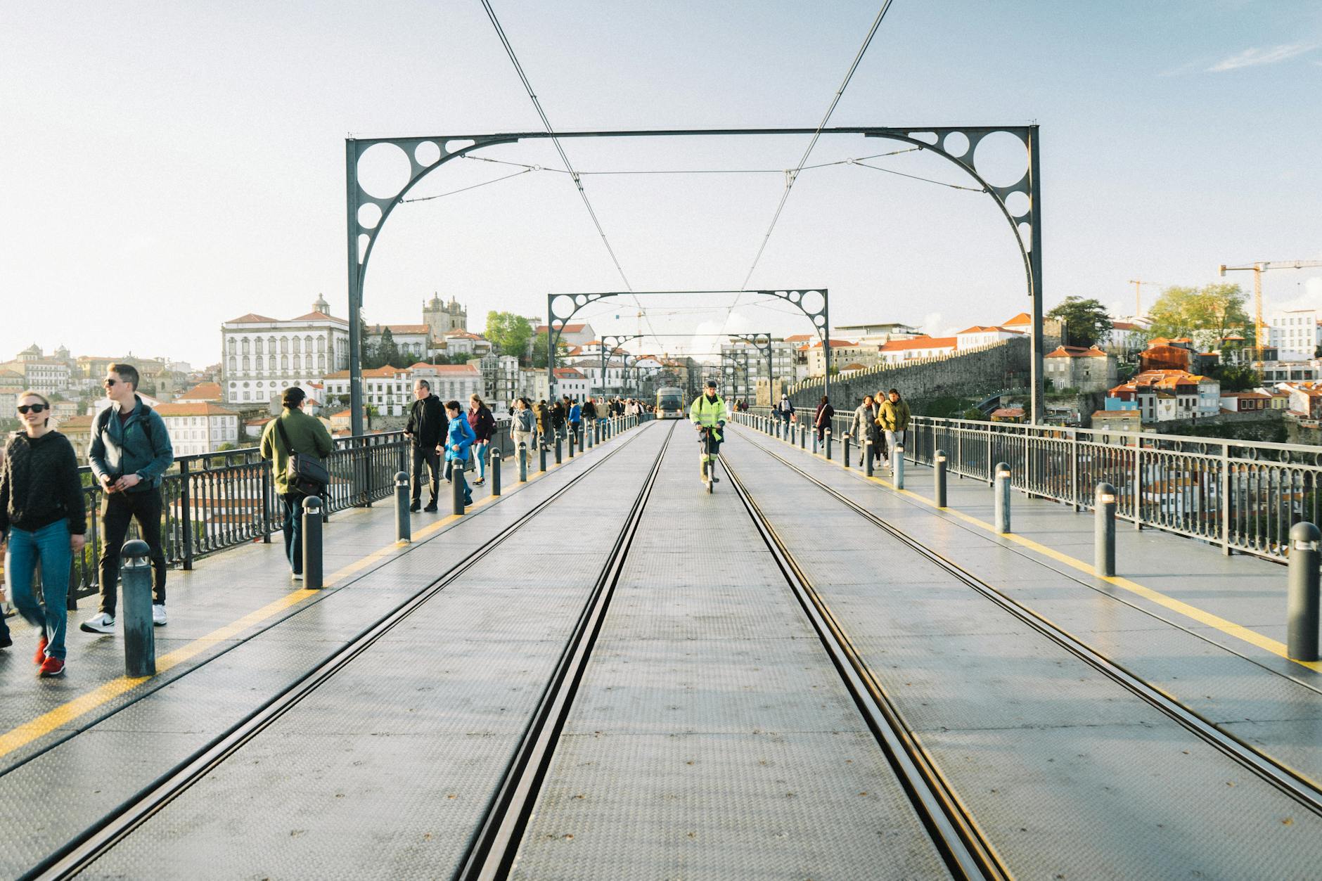 People walking and cycling on Porto's Luis I Bridge