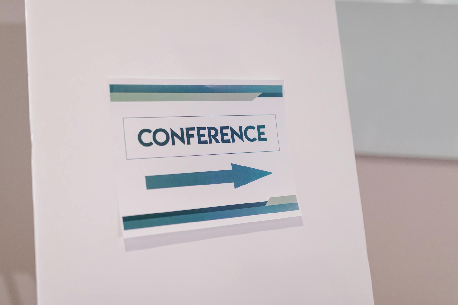 Conference directional sign guiding attendees indoors