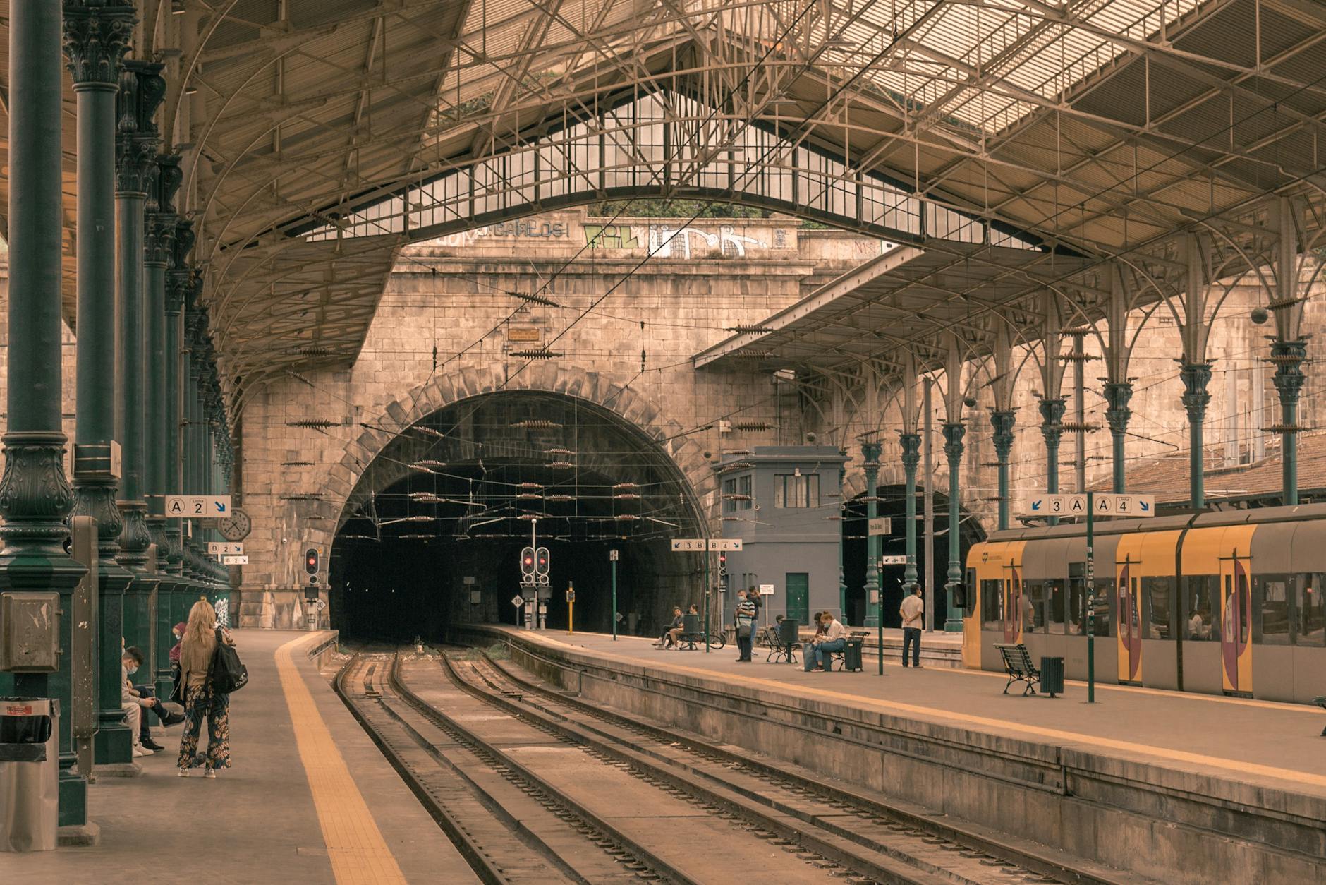 Sao Bento train station with commuters, trains, and historic architecture