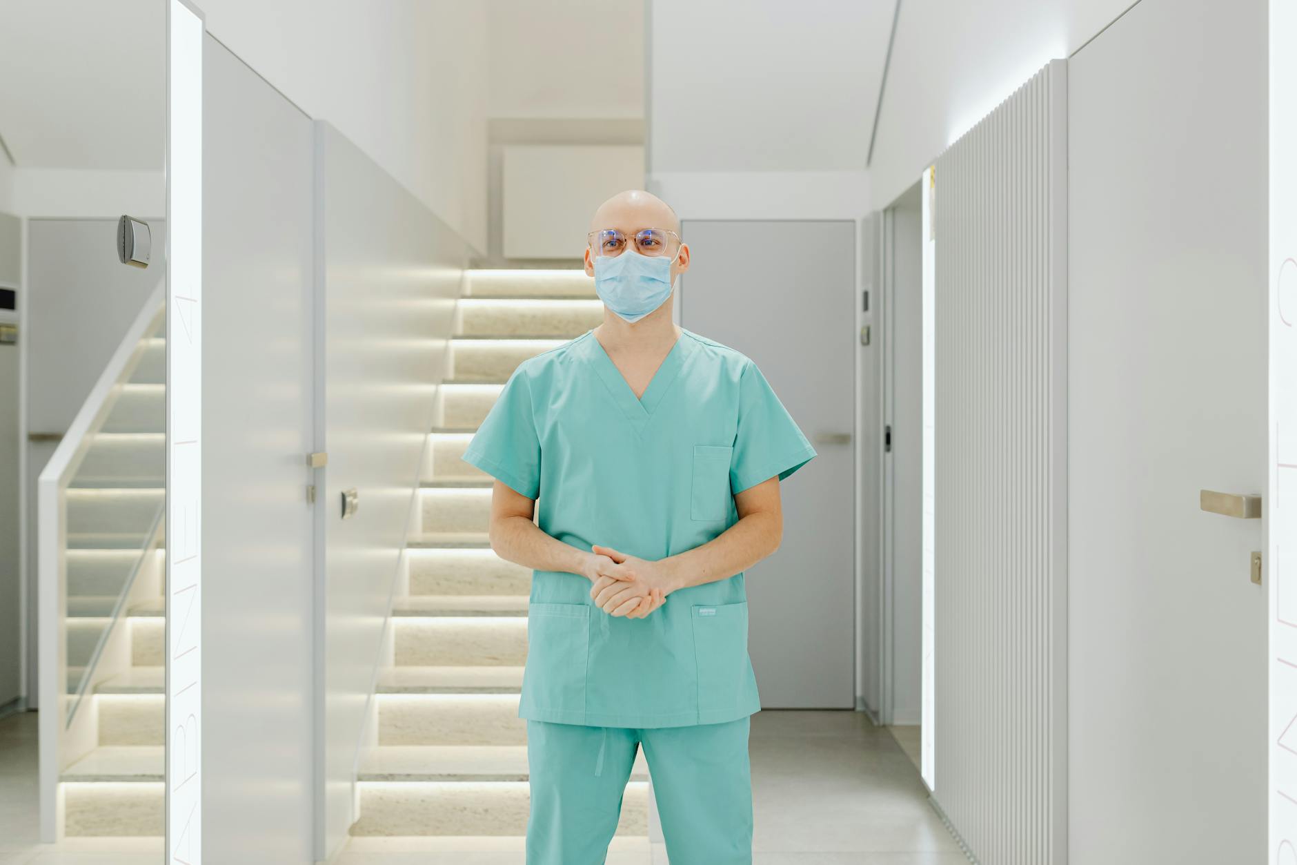 Healthcare worker standing in a clinic hallway