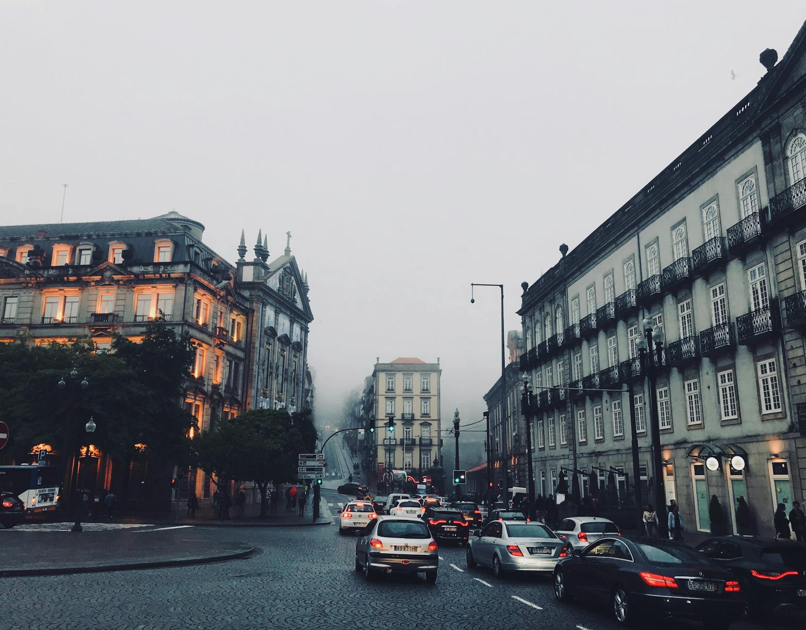Foggy Porto street with traffic and historic buildings