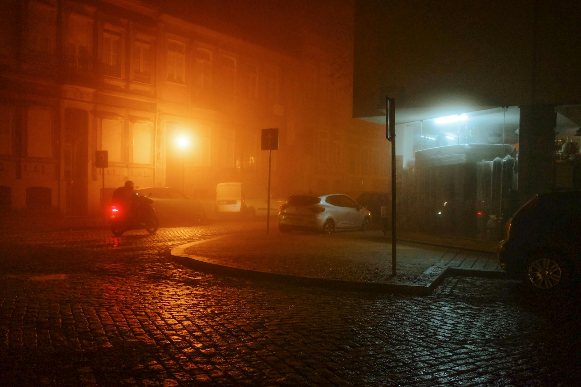 Misty Porto street scene at night with streetlights