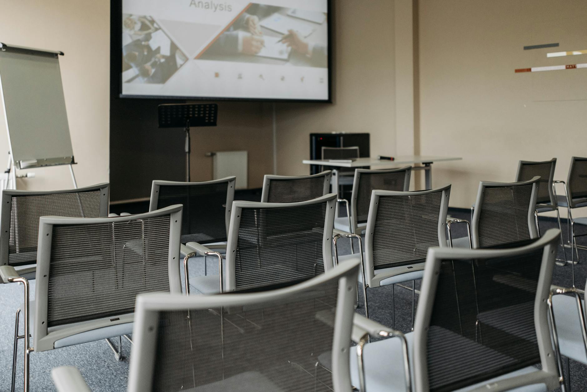 Conference room with projector screen and rows of chairs