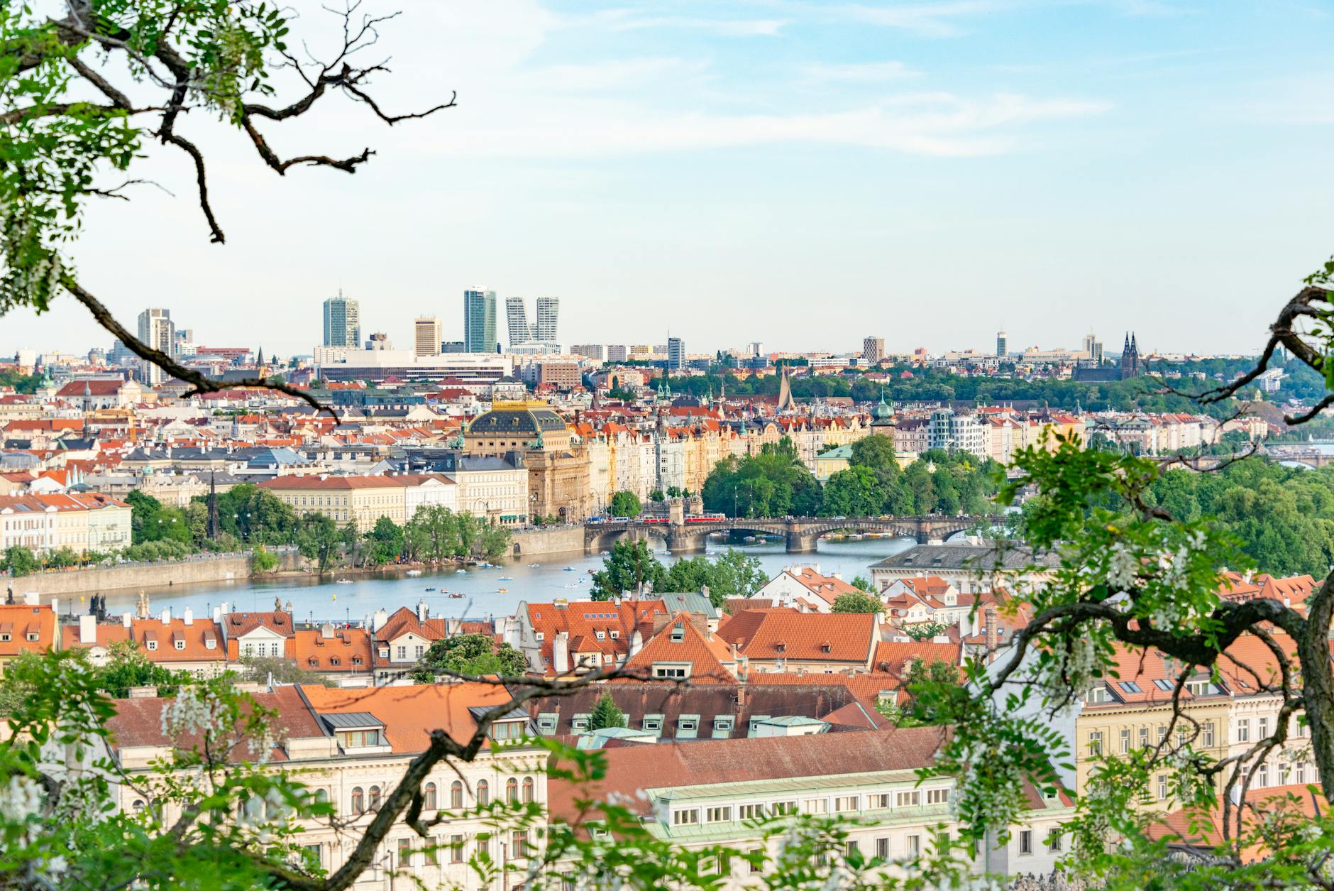 Aerial view of Prague with greenery along the Vltava River