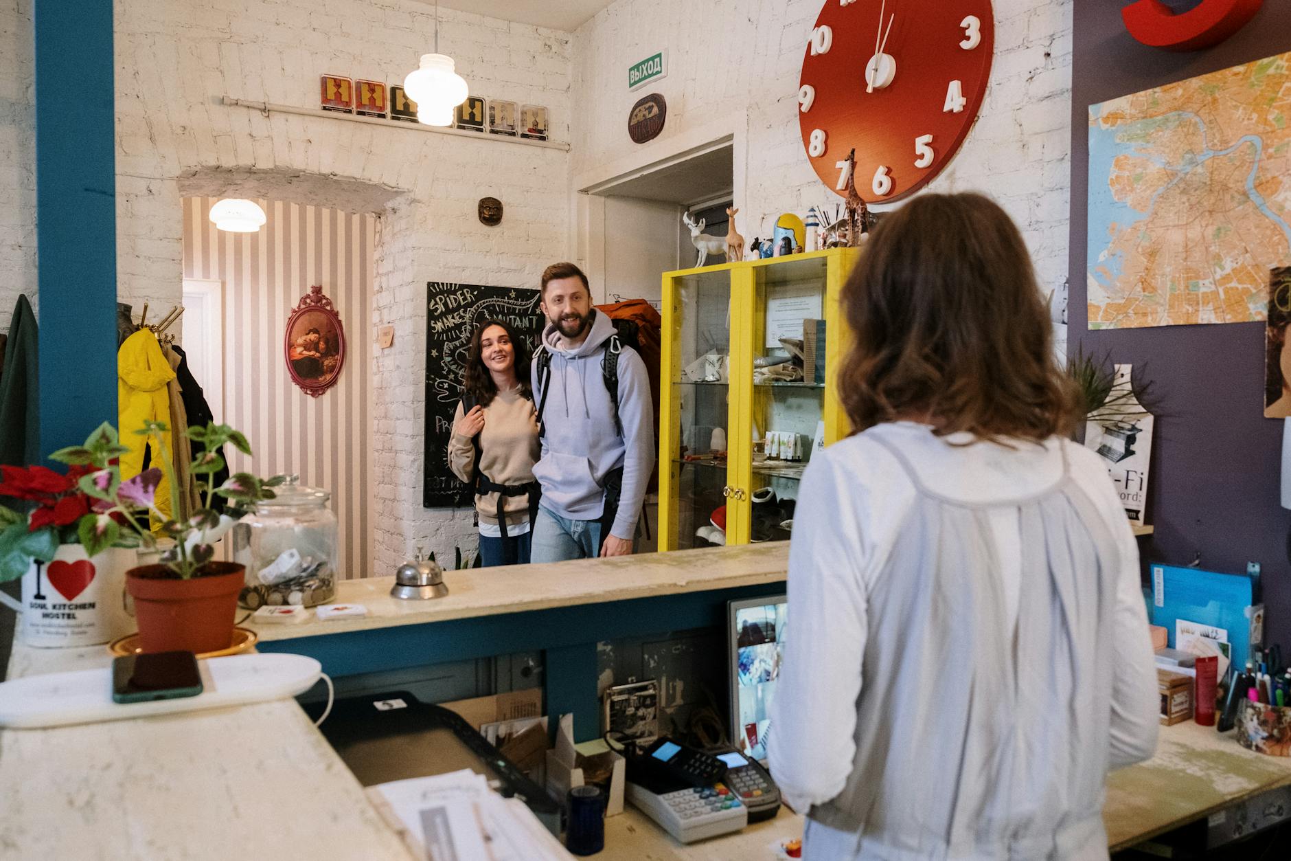 Travelers checking in at a hostel reception desk