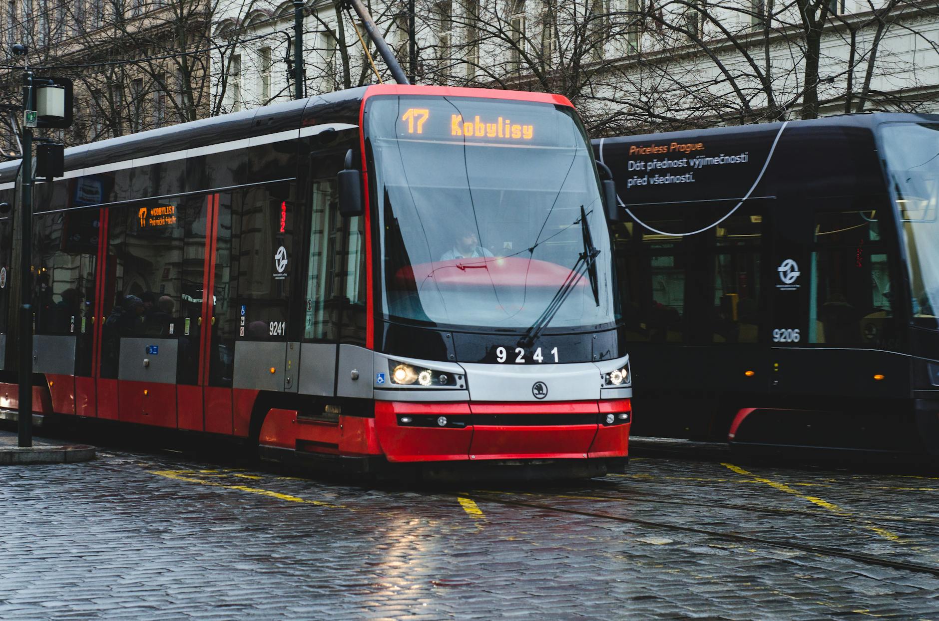 Modern tram on a wet street in Prague
