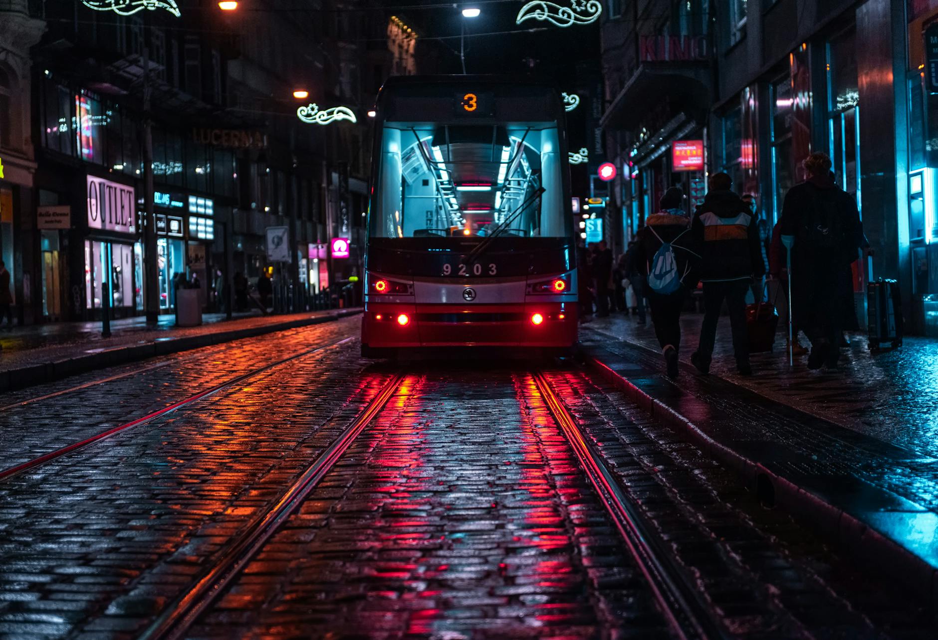Tram on a rainy cobblestone street in Prague