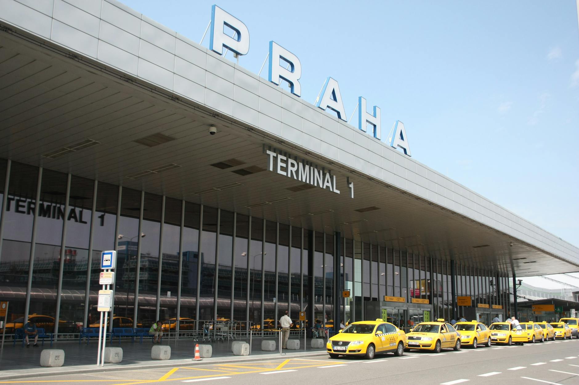 Praha Airport Terminal 1 with yellow taxis outside