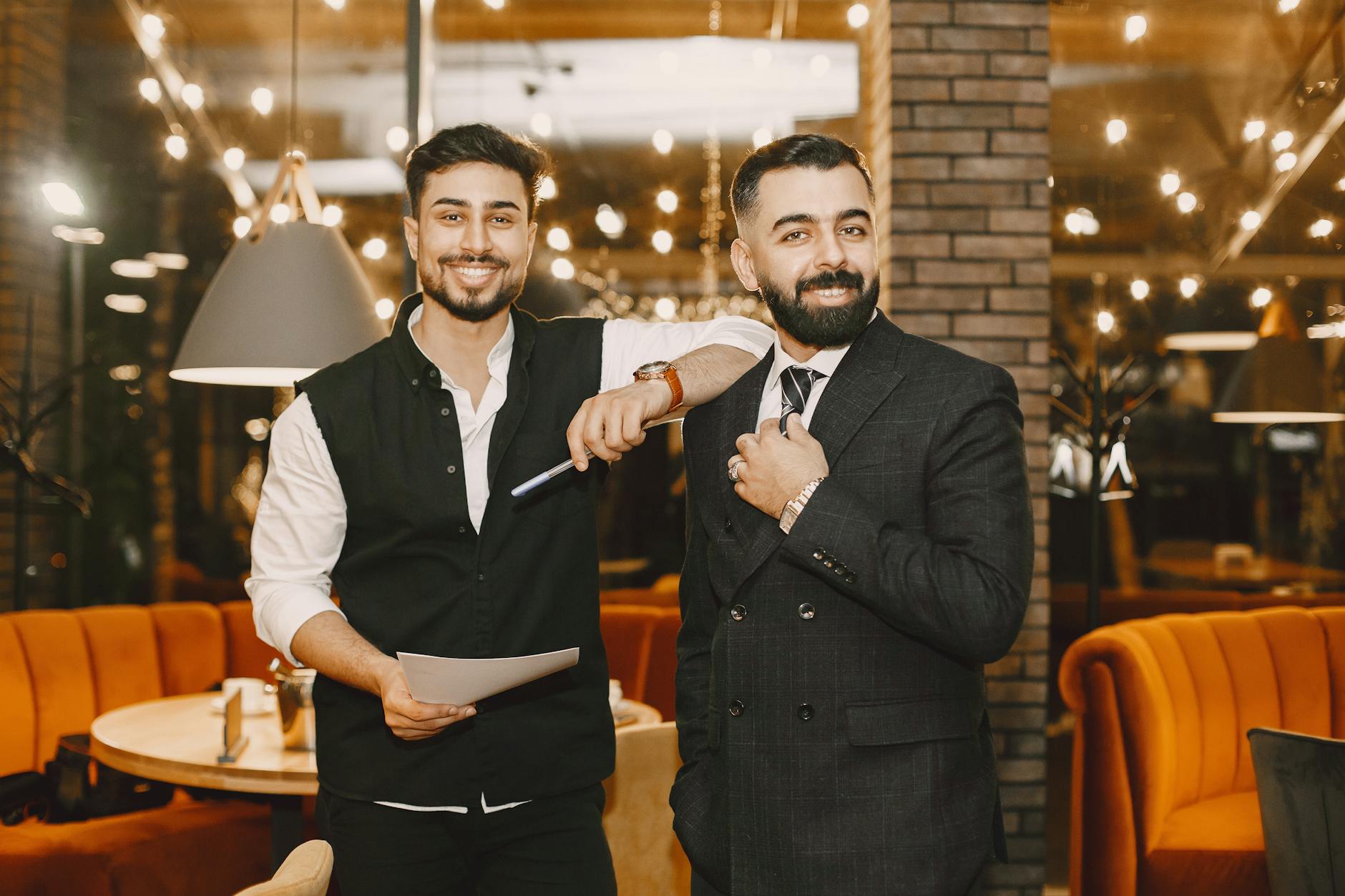 Business traveler and waiter in a warm restaurant setting