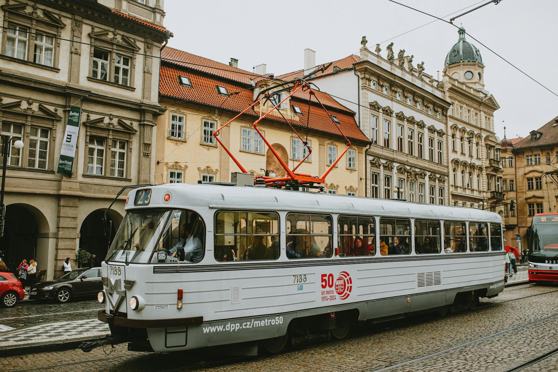 Vintage tram on a busy historic Prague street