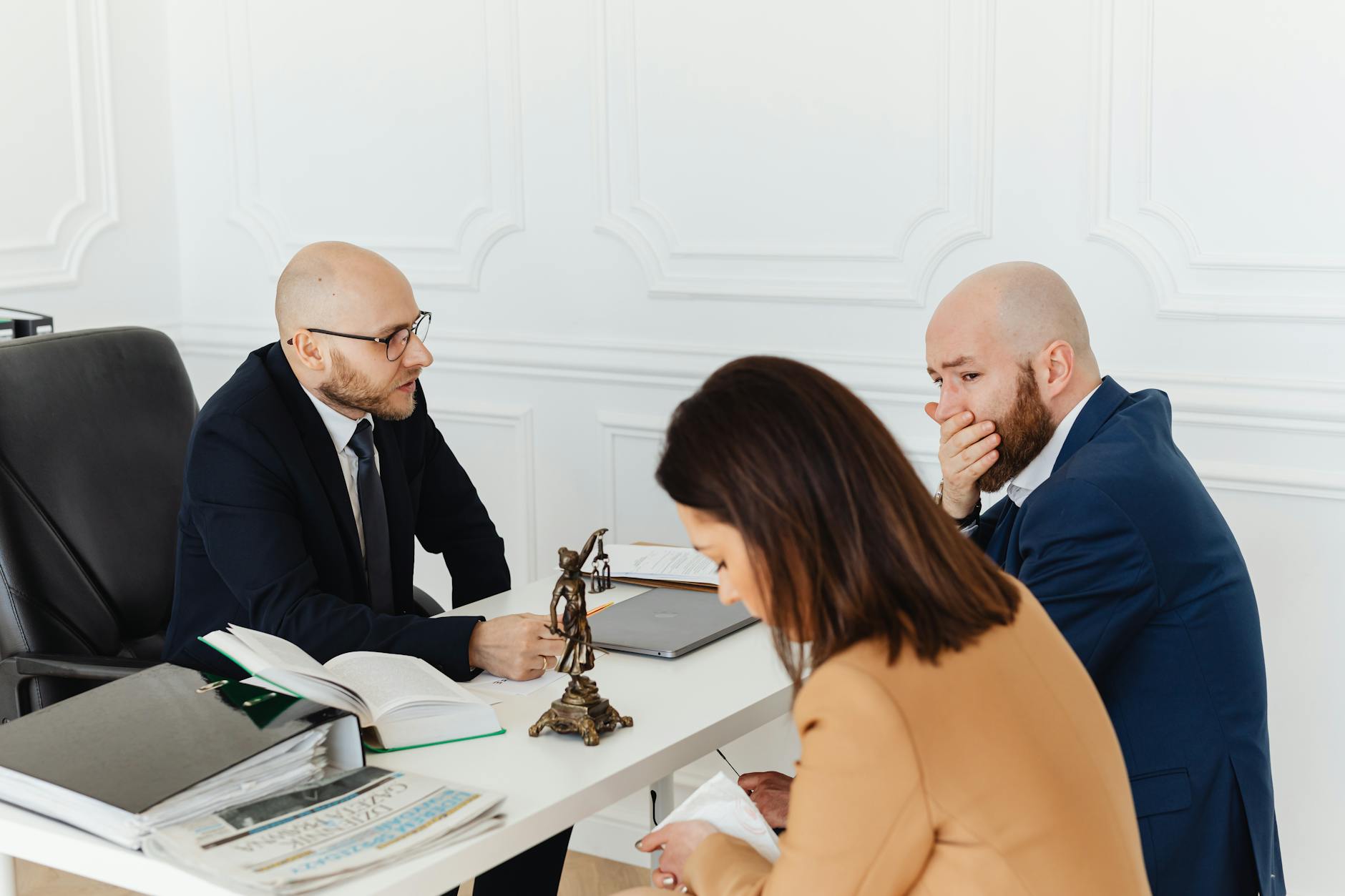 Professional consultation in an office with three adults