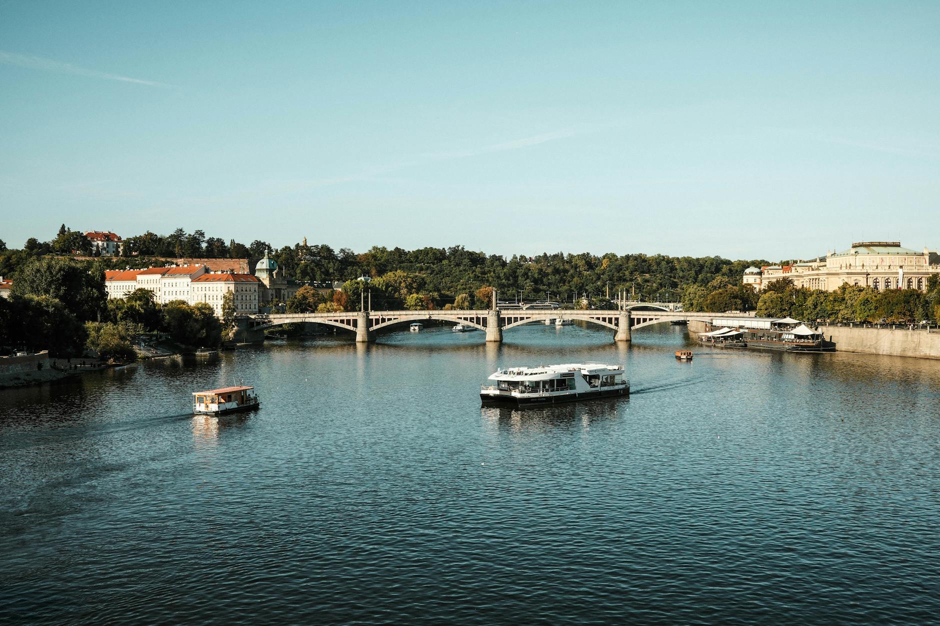 Vltava River with boats and historic Prague architecture
