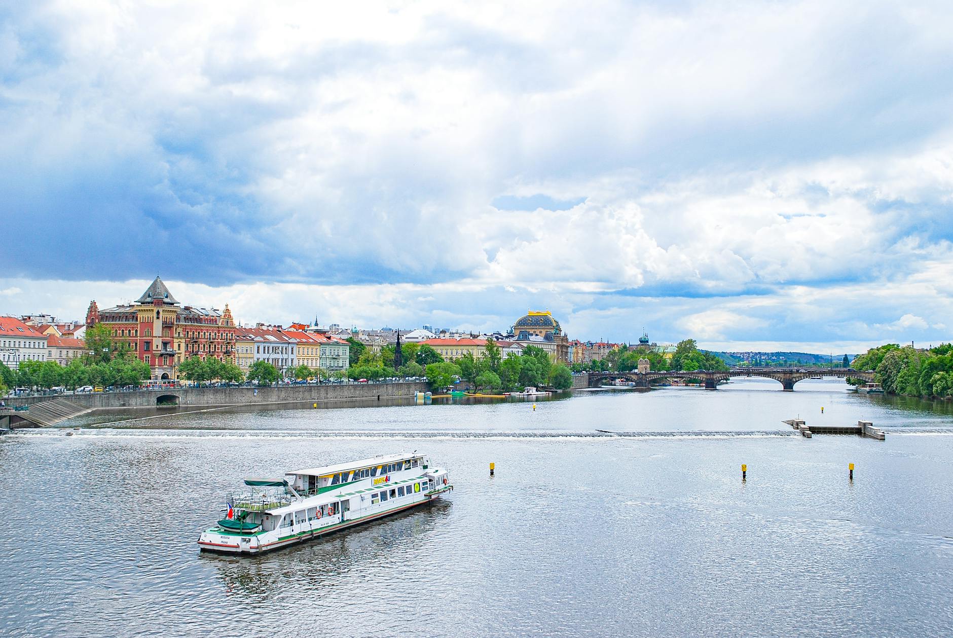 Ferry on the Vltava River with historic Prague architecture