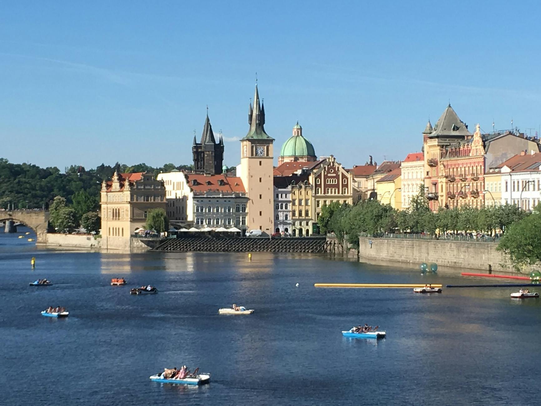 Historic Prague waterfront with boats on the Vltava River
