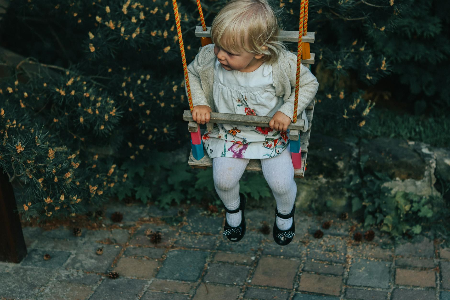 Toddler on a swing in a Prague park