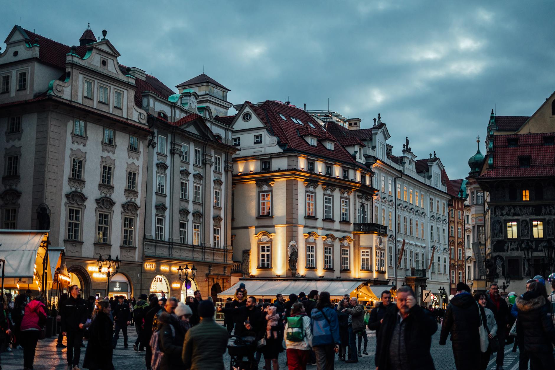 Crowd in Prague historic town square at dusk