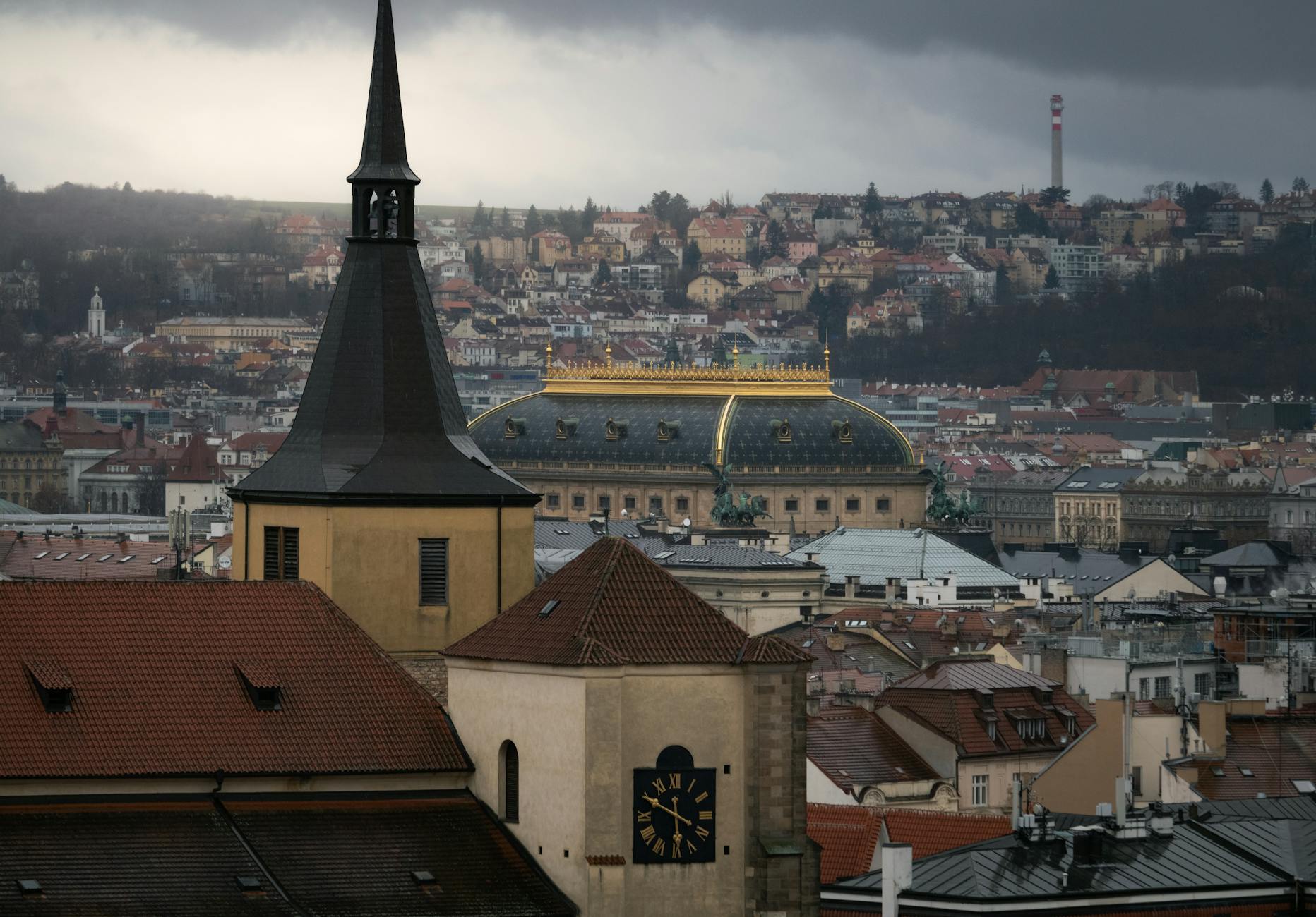 Moody Prague skyline with historic architecture under clouds