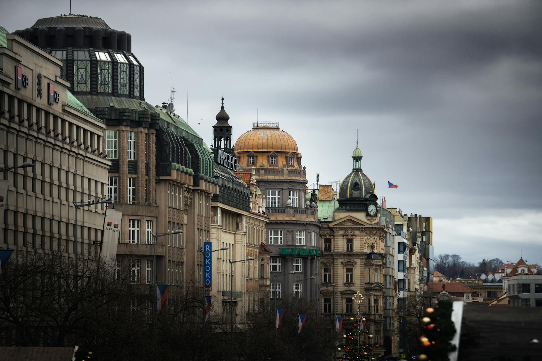 Historic Prague buildings under a dramatic cloudy sky