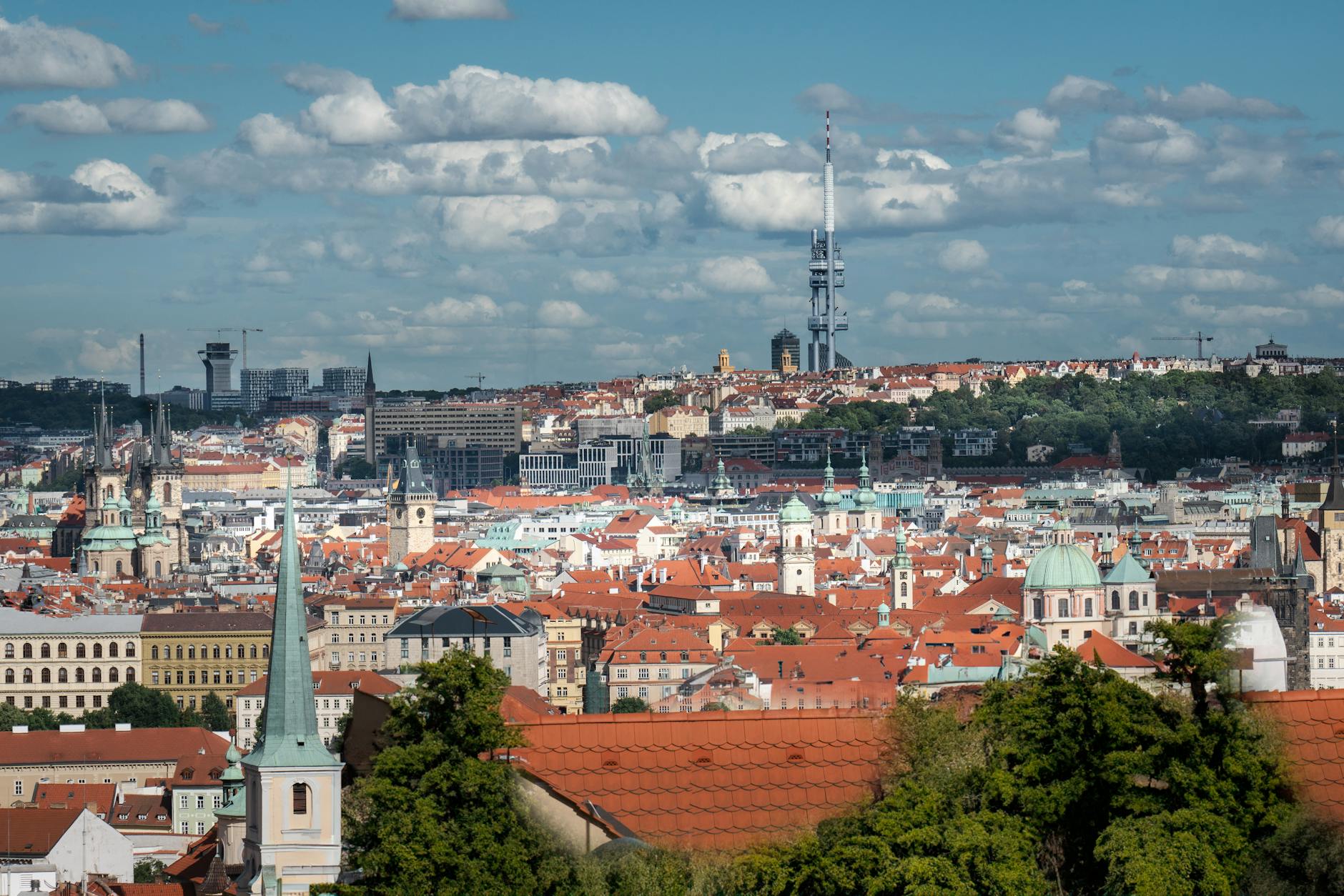 Aerial cityscape of Prague with red rooftops and historic architecture
