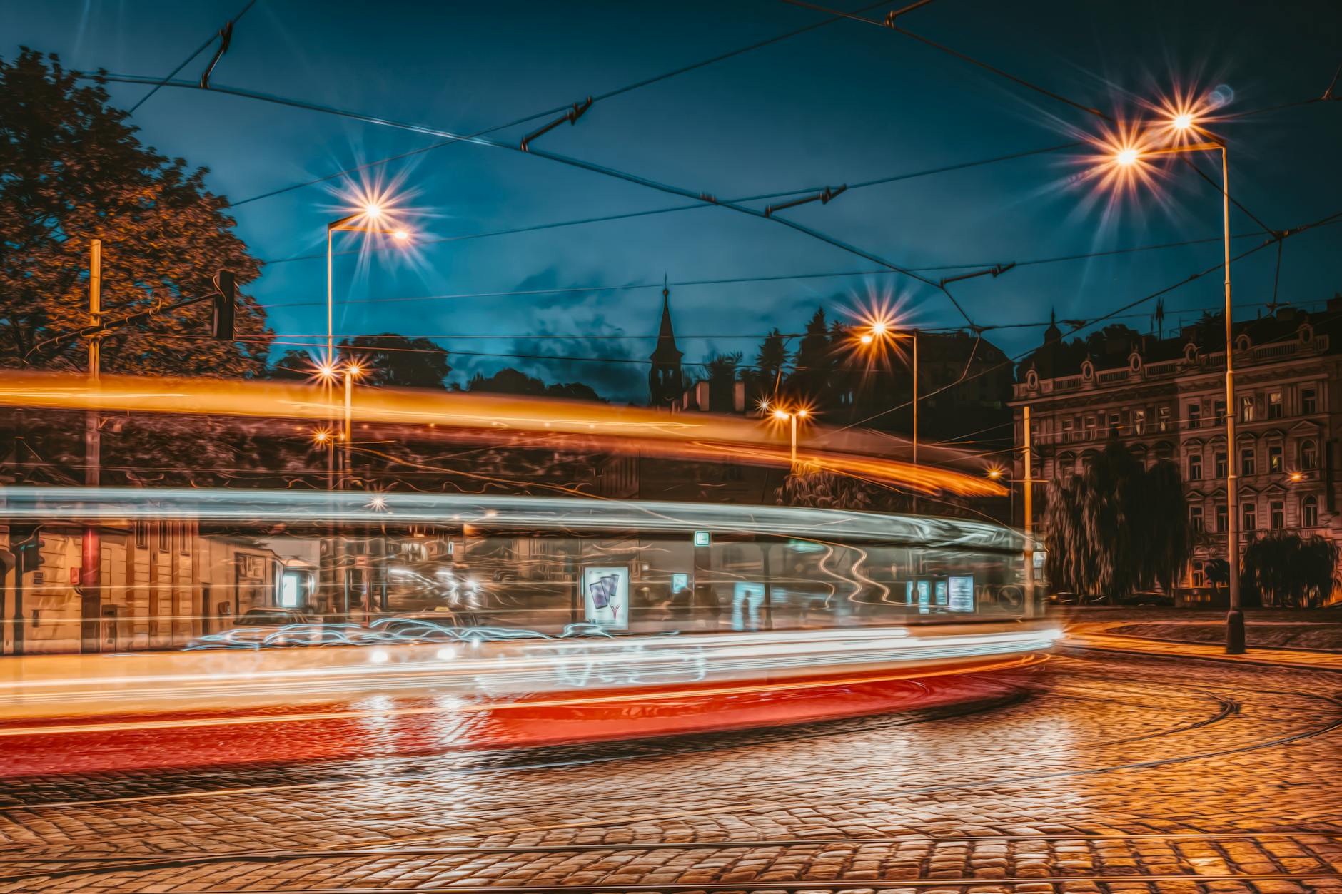 Prague tram light streaks on a cobblestone street at night