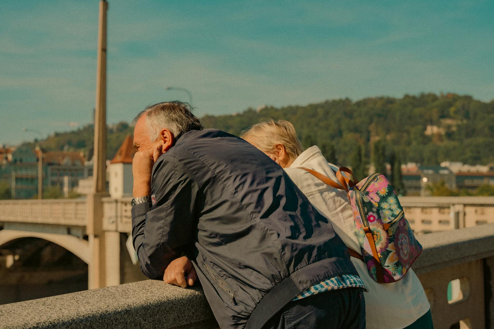 Older couple overlooking Prague architecture on a sunny day