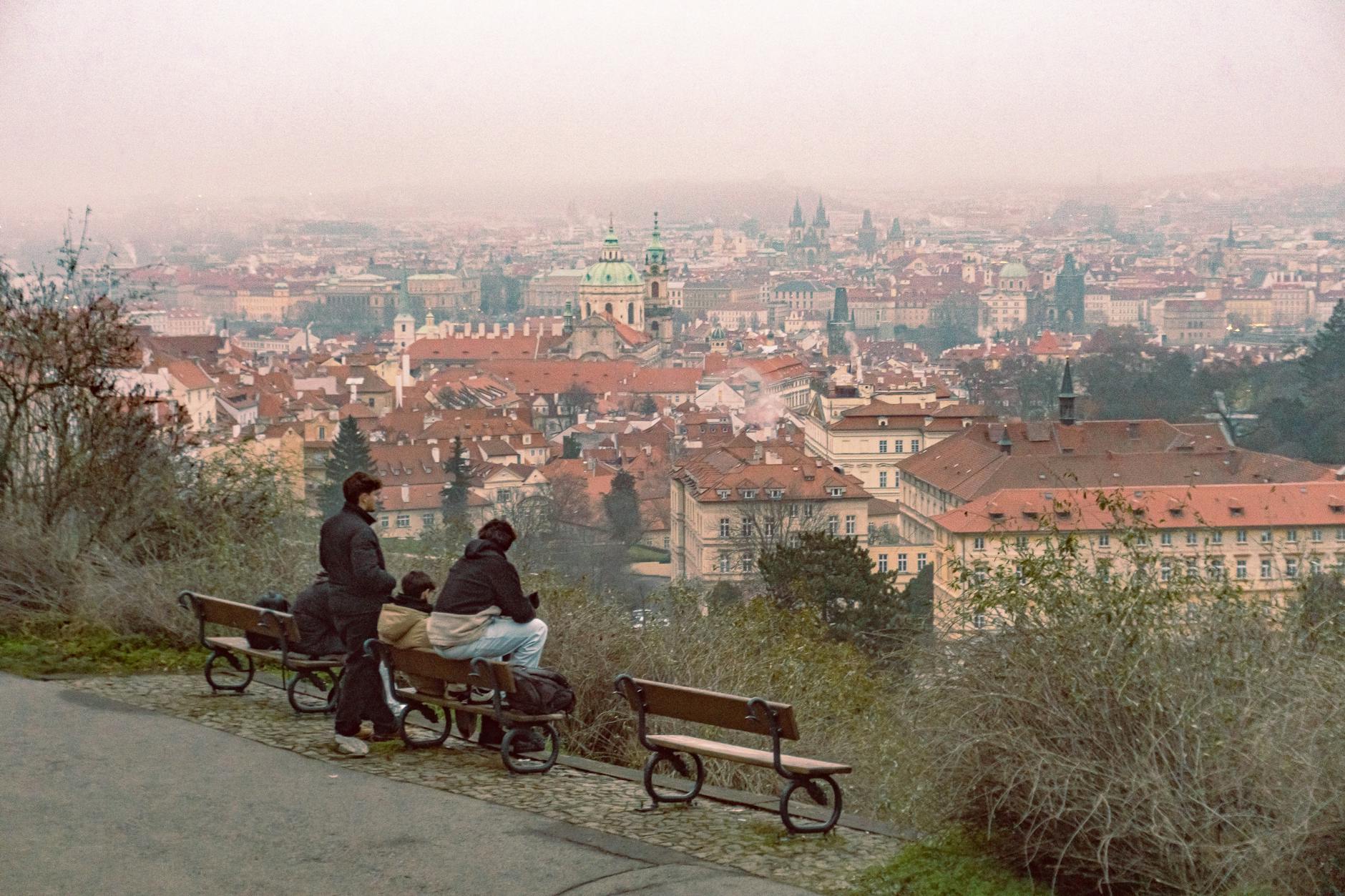 Prague skyline from a hilltop with benches