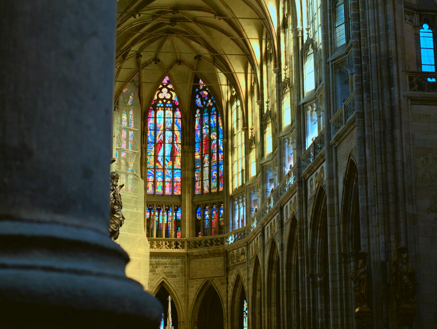 Stained glass and Gothic architecture inside St. Vitus Cathedral in Prague