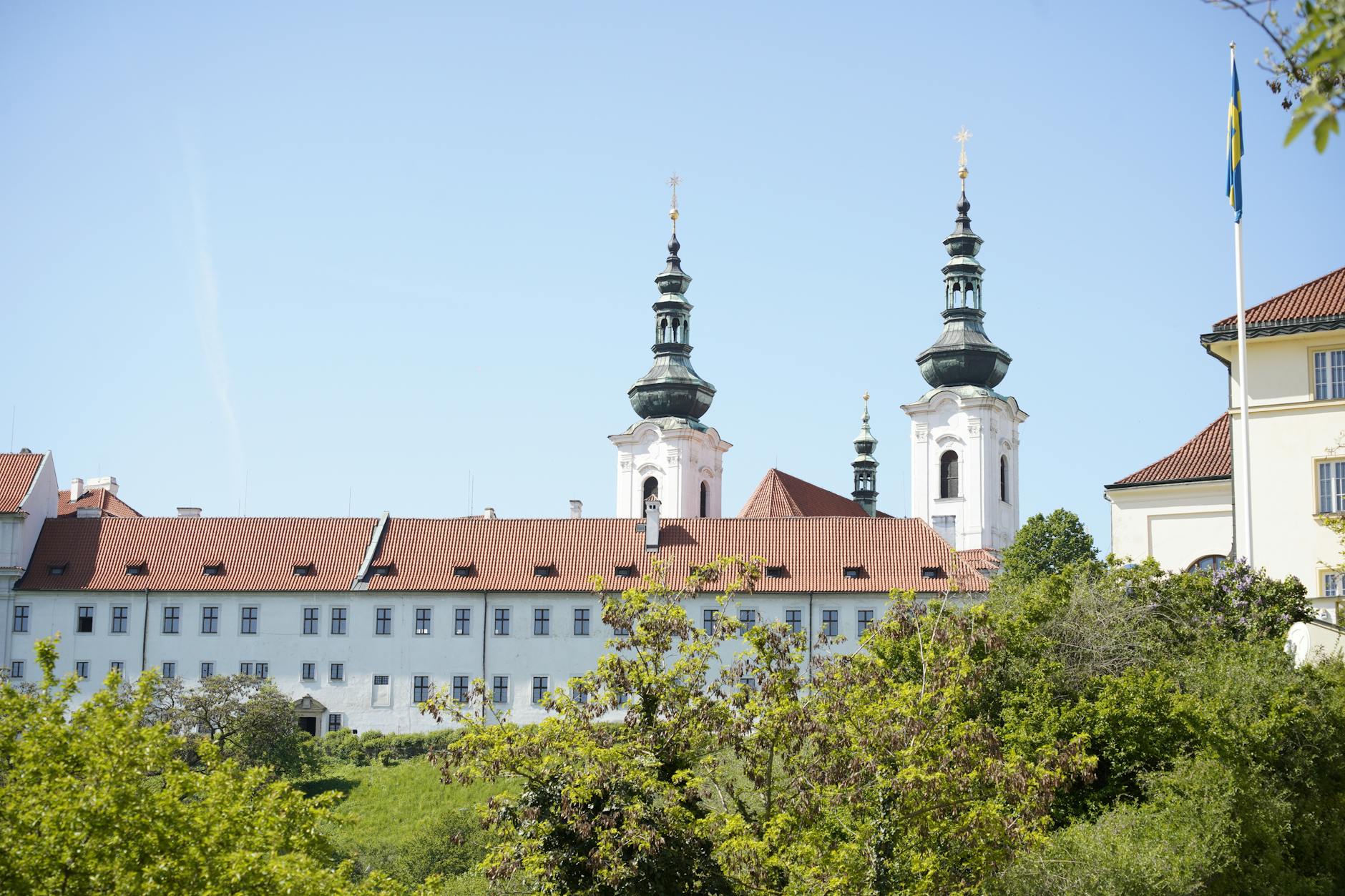 Historic monastery with spires in Prague under clear blue sky