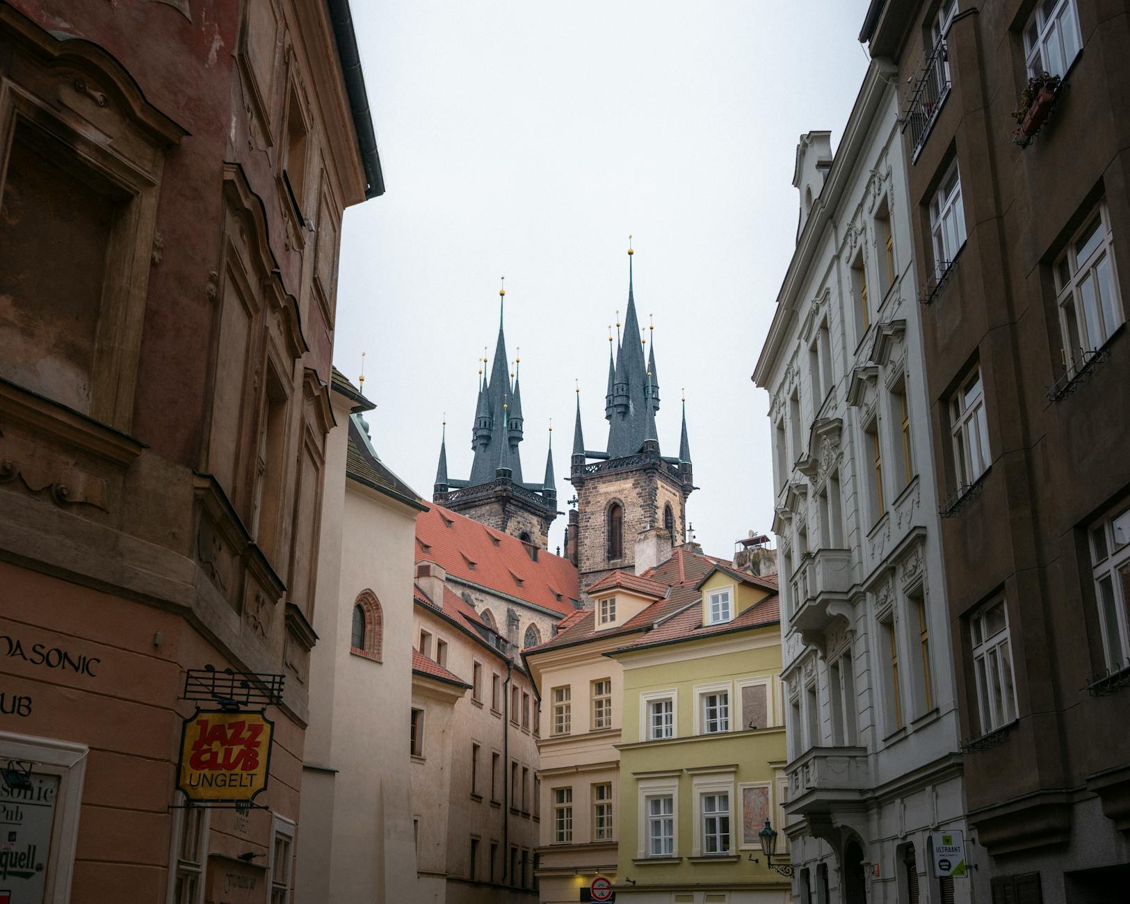 Church spires in Prague Old Town framed by historic architecture