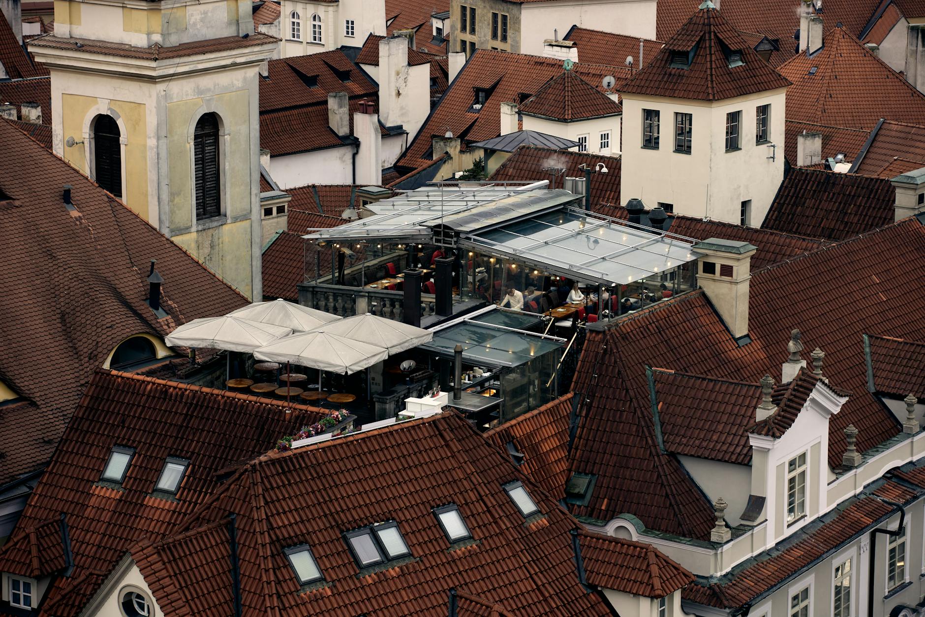 Rooftop restaurant above terracotta roofs in a historic European city