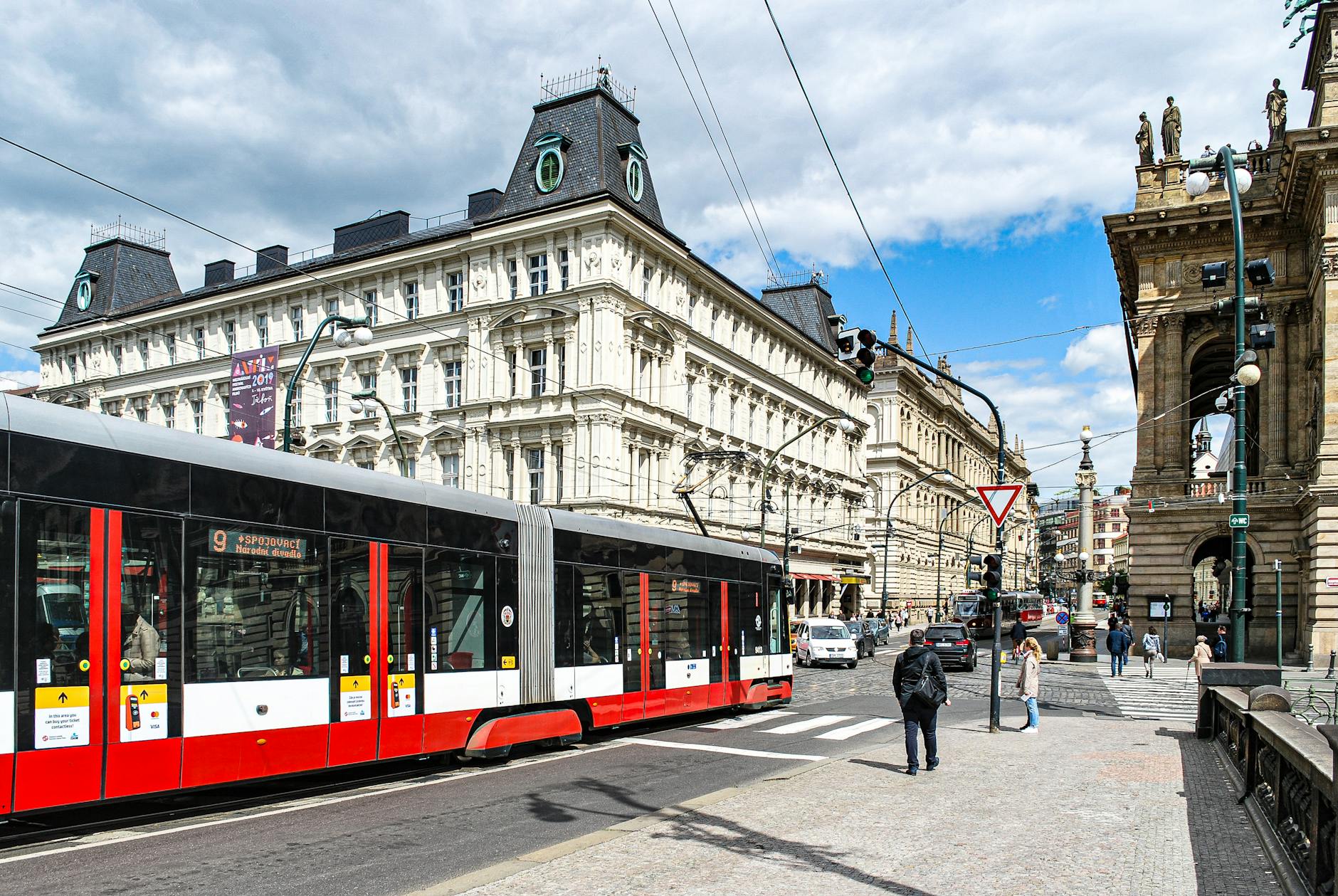 Modern tram passing historic architecture in Prague