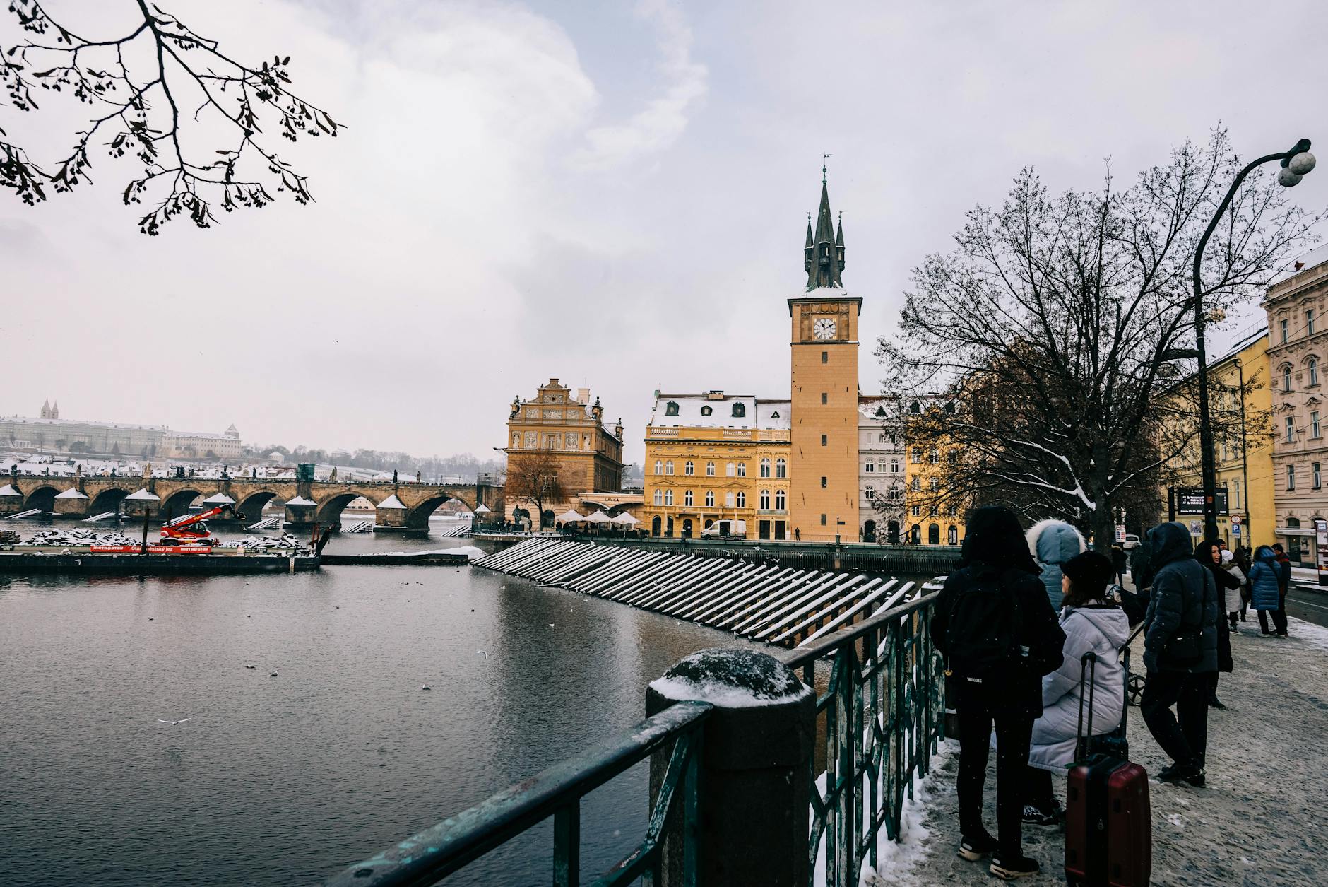 Charles Bridge and Prague architecture in winter snow