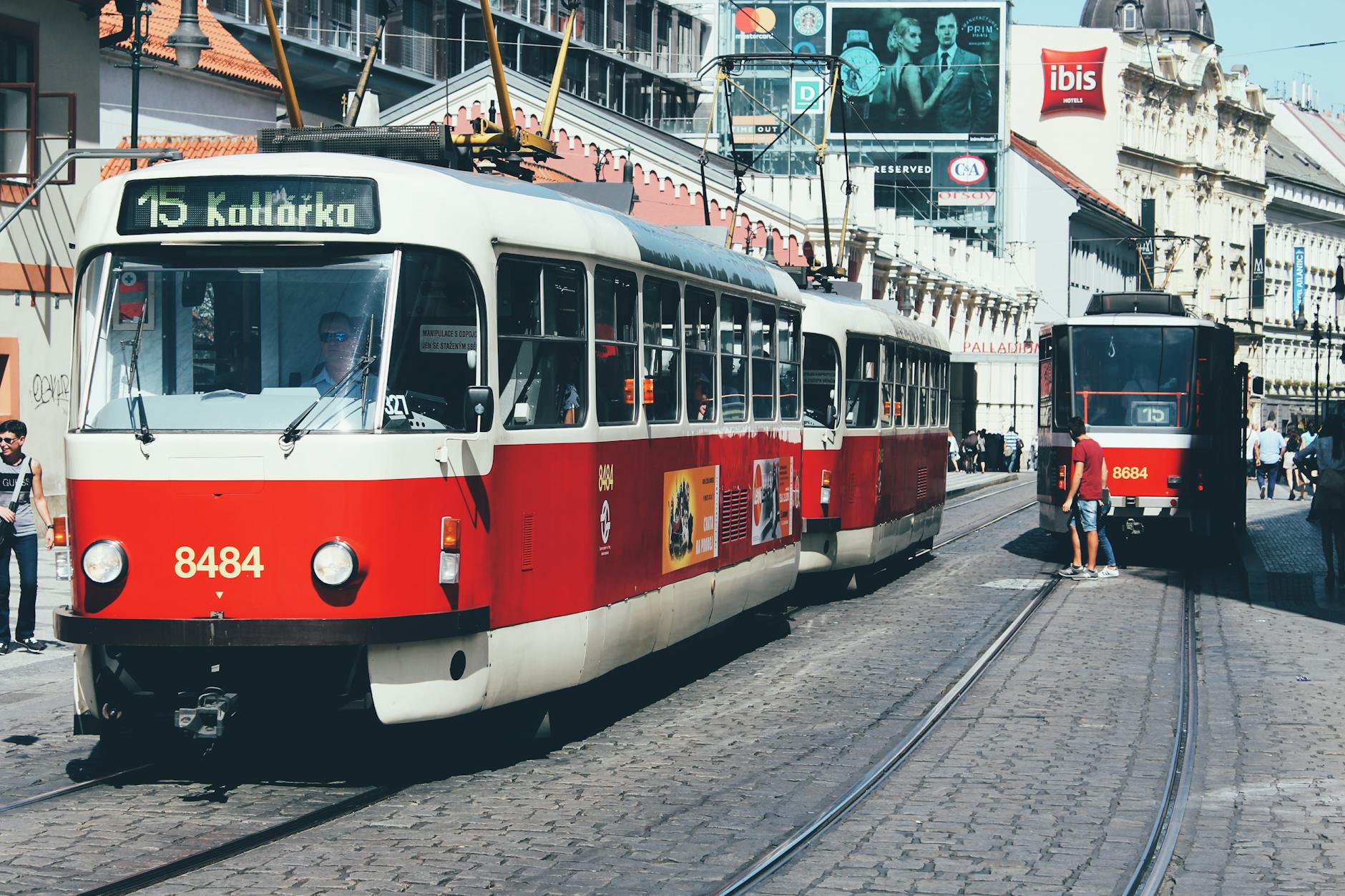 Classic red trams on a sunny European city street