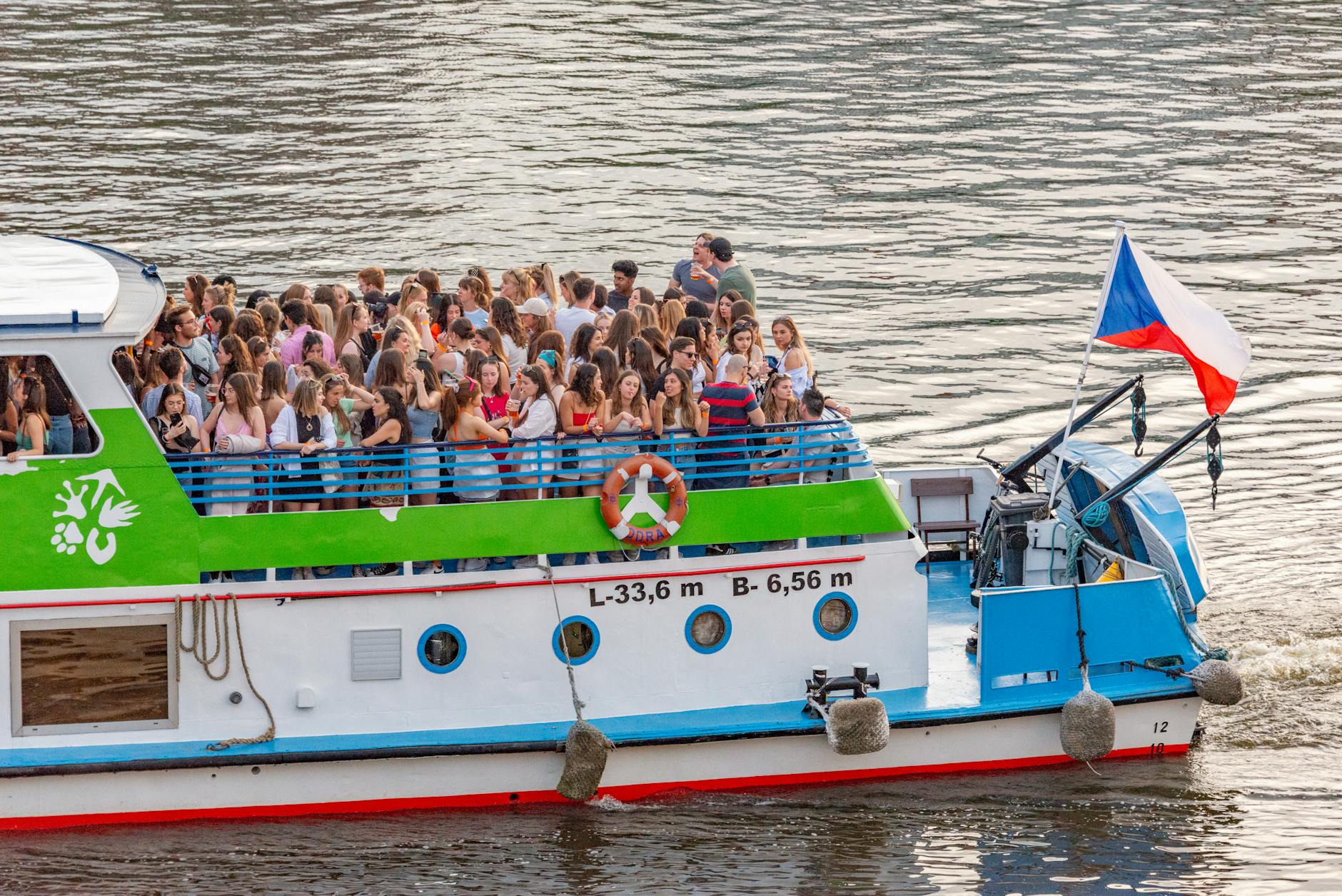 Sightseeing boat carrying tourists on the Vltava River in Prague