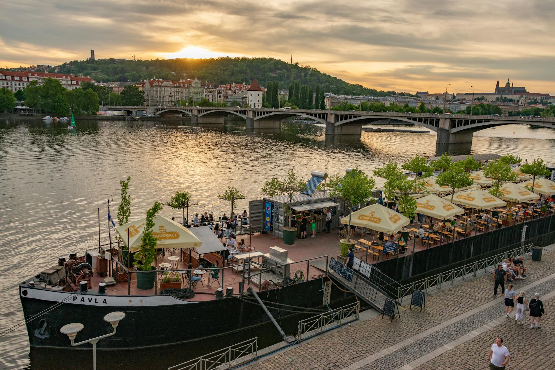 Boat restaurant on the Vltava River at sunset in Prague
