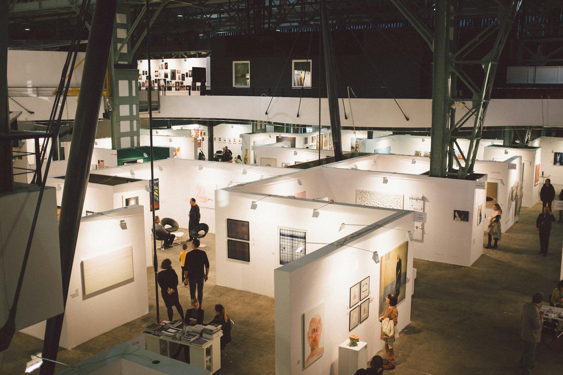 People standing near displays in a spacious exhibition hall