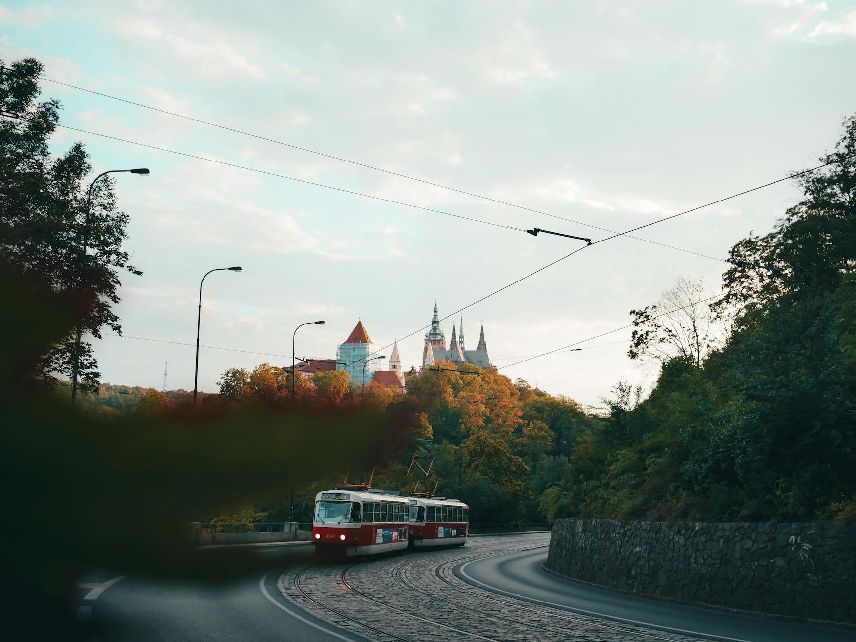 Vintage tram in Prague with castle backdrop