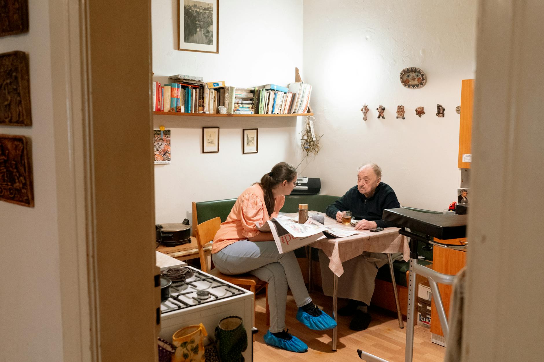 Caregiver and senior having a friendly conversation over coffee in Prague