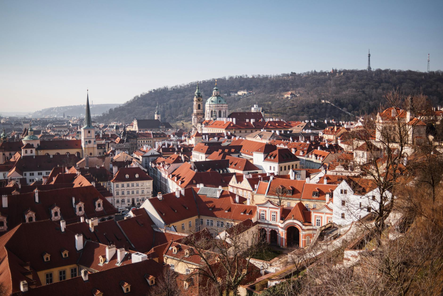 Prague residential buildings and cathedral exterior in autumn light