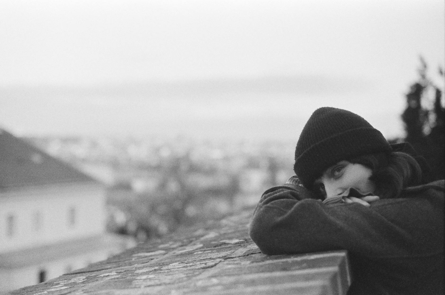 Woman seated on a Prague rooftop in winter