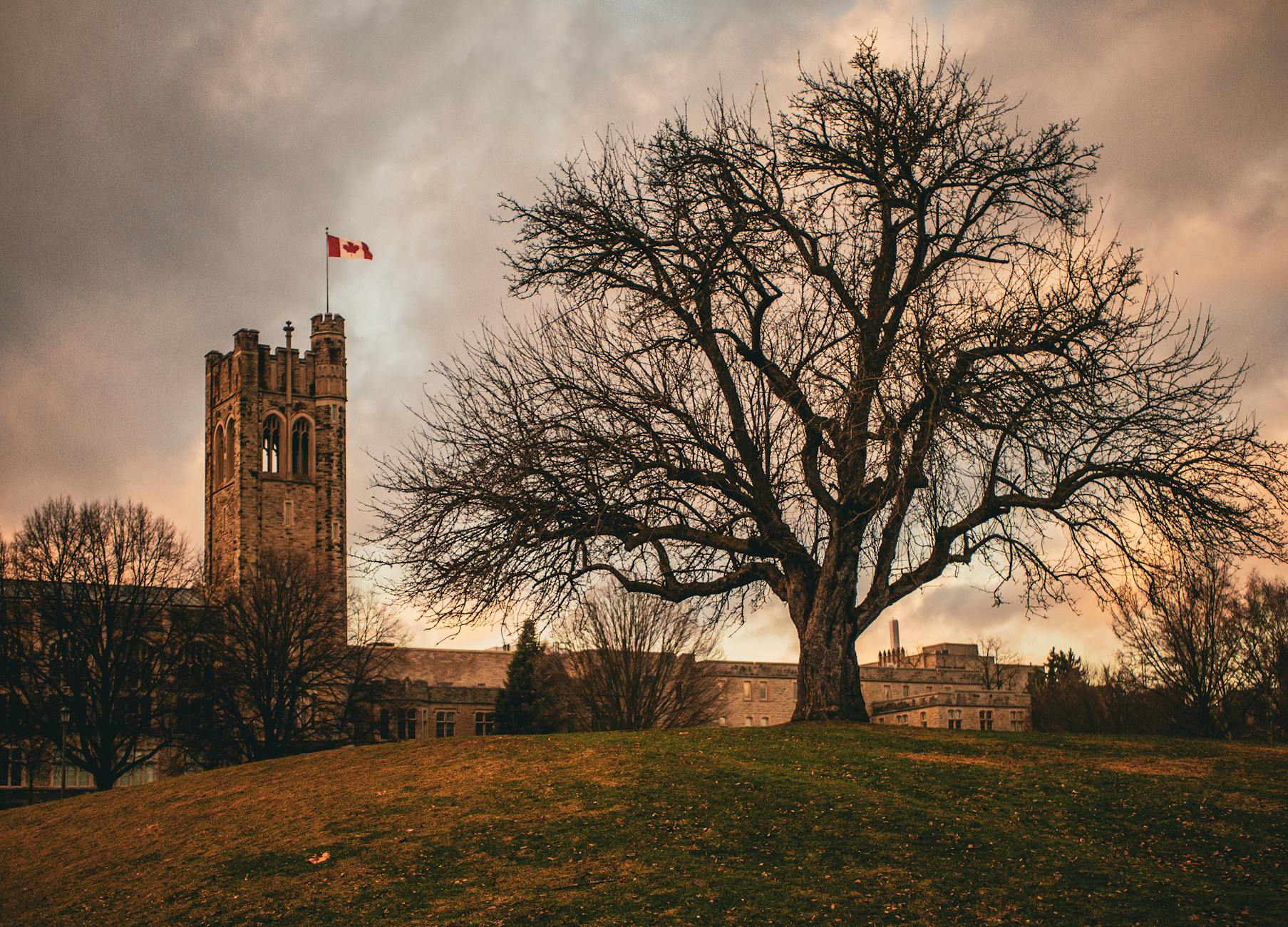 Historic Canadian building at dusk with a flag