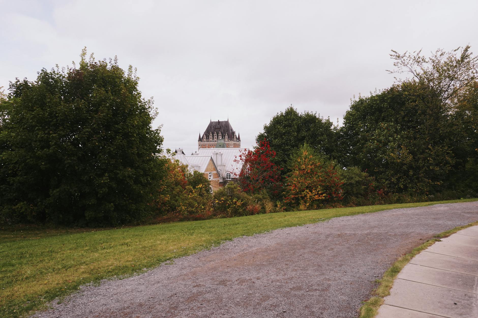 Pathway leading toward Chateau Frontenac through autumn trees