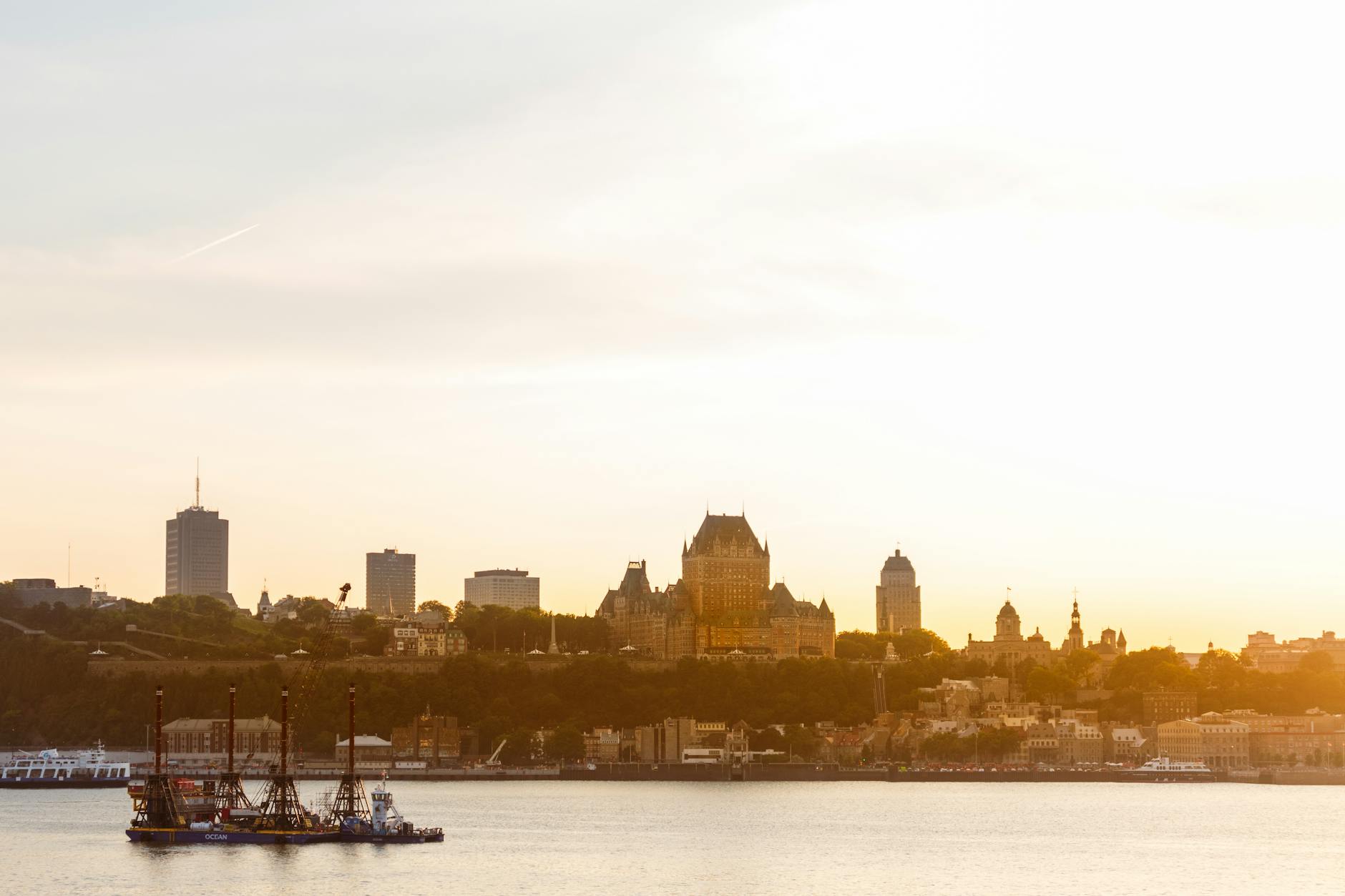 Quebec City skyline at sunset with Chateau Frontenac and the St. Lawrence River